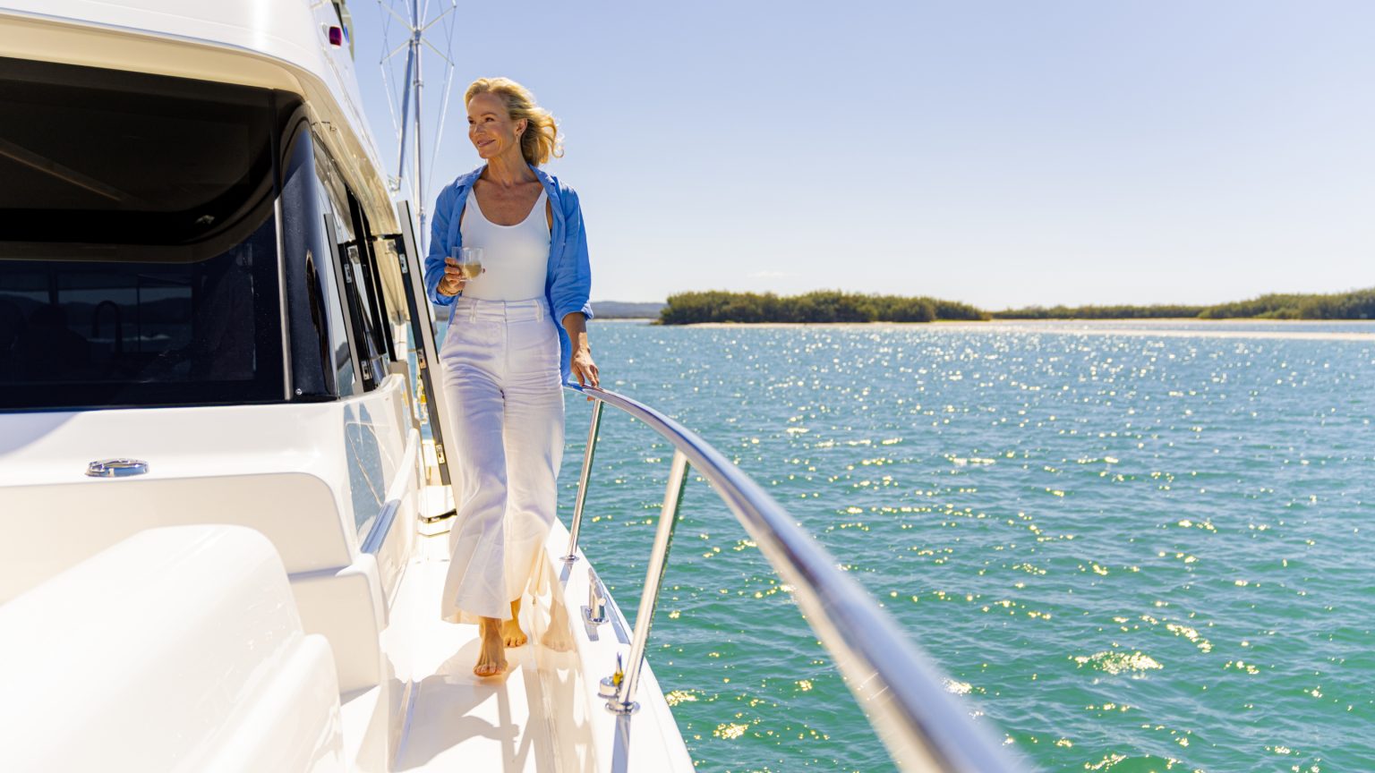 Boat deck — blue shirt, champagne